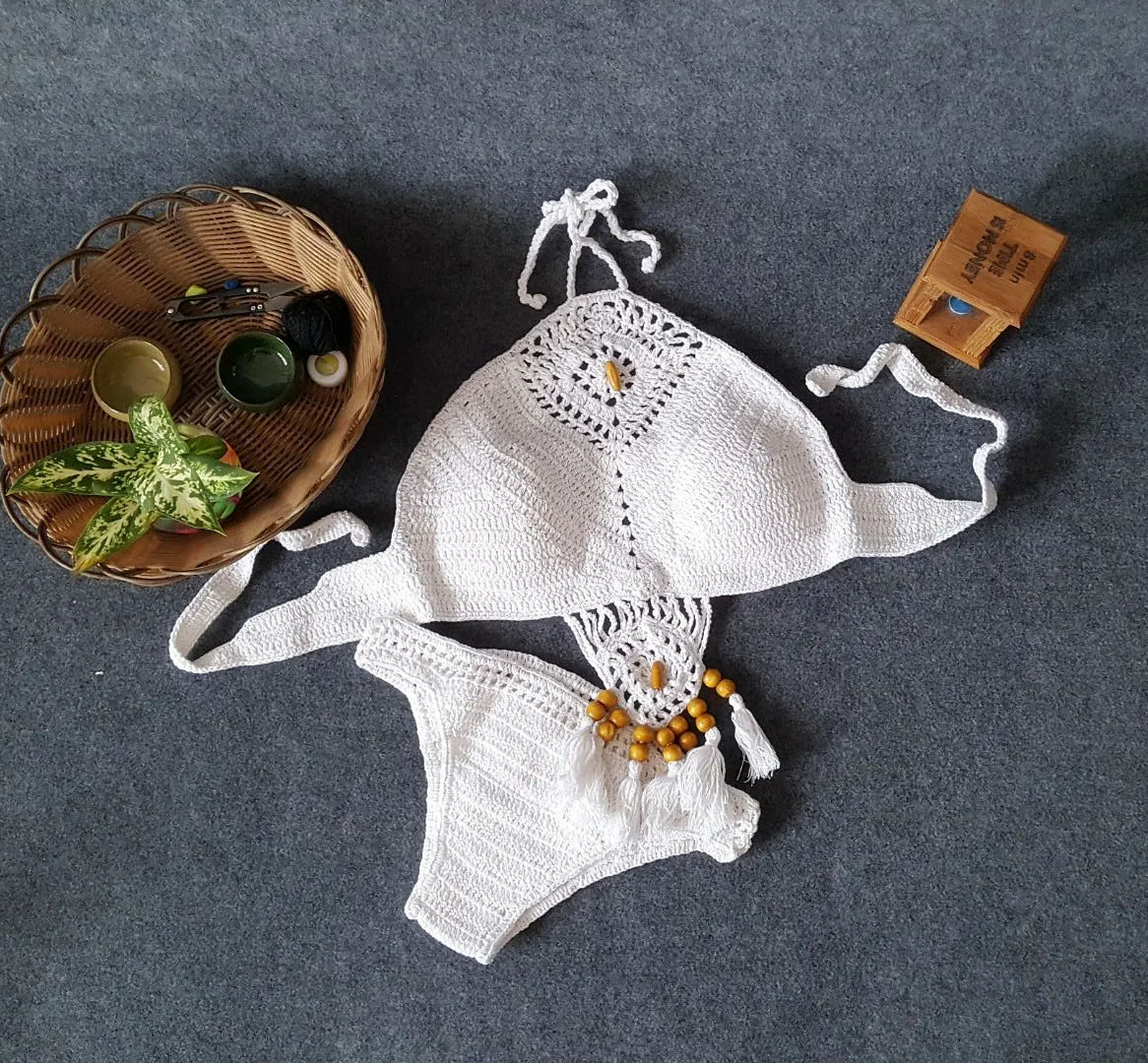 Crochet tassel bikini set for women in black, showing textured weave and tassel trim, beach style