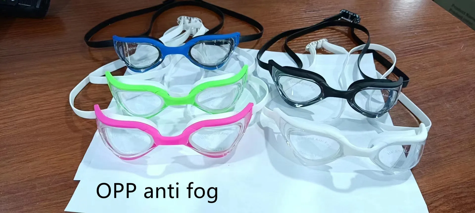 Racing HD anti-fog swimming goggles with polycarbonate lenses and silicone seal, shown with adjustable nose bridges.