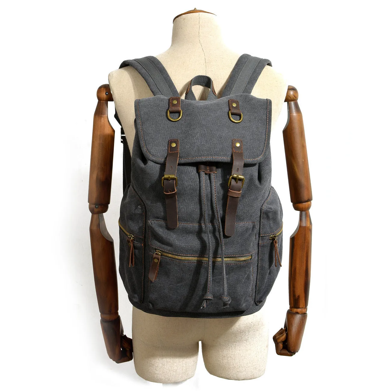 Canvas casual backpack with crazy horse leather trim in brown side view showing main compartment and shoulder strap