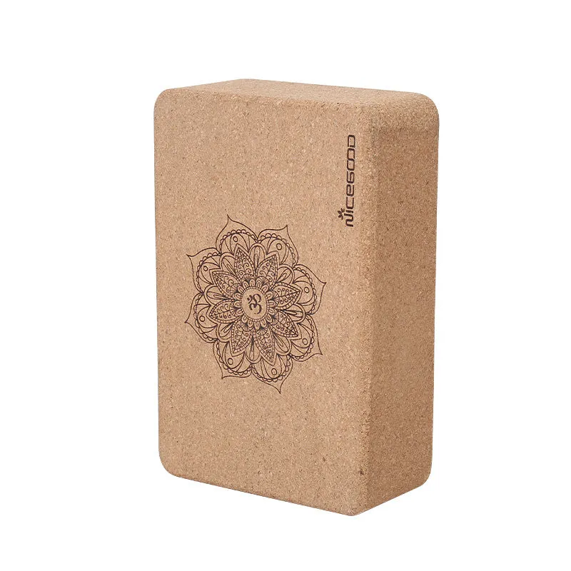 High-density natural cork yoga brick with rounded edges on a wooden floor
