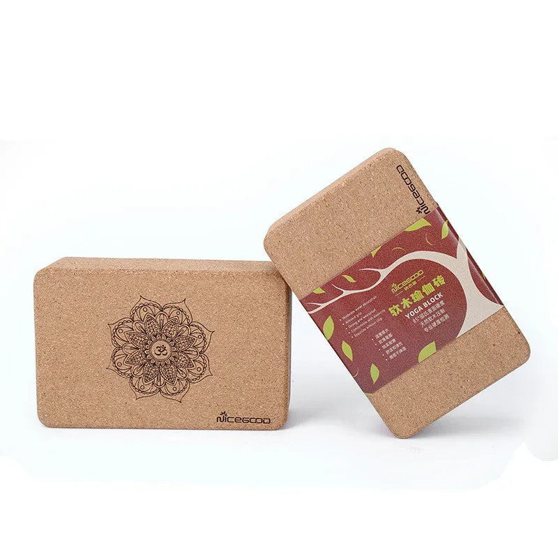 High-density natural cork yoga brick with rounded edges on a wooden floor