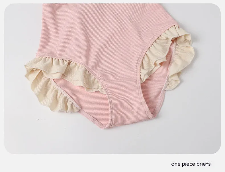 Pink women's conservative one-piece swimsuit with a Siamese design detail on a mannequin.
