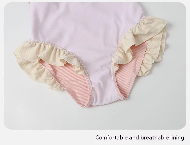 Pink women's conservative one-piece swimsuit with a Siamese design detail on a mannequin.
