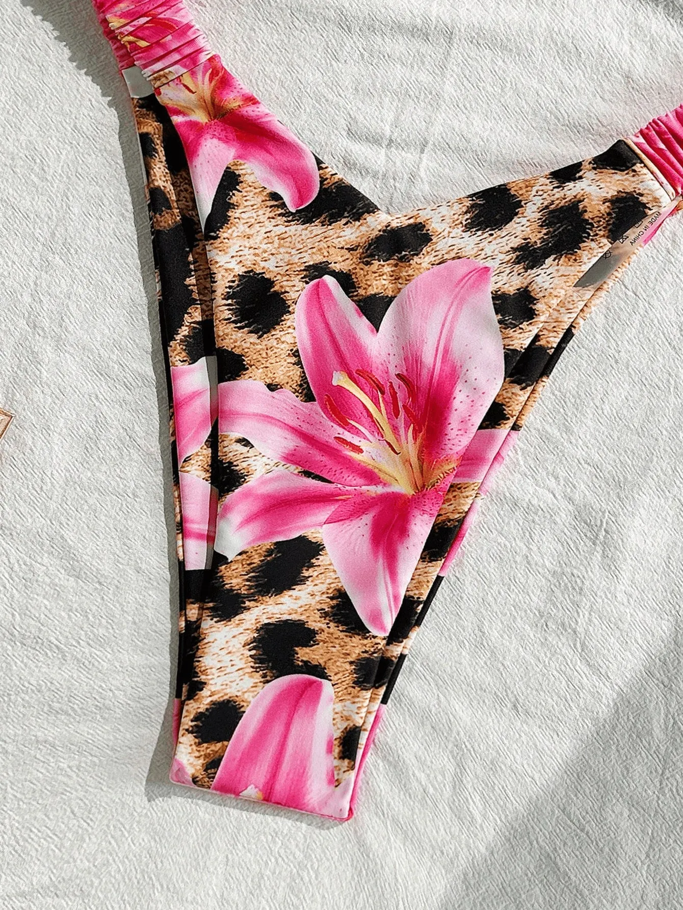 Pink leopard print women's tube top split bikini swimsuit on white background