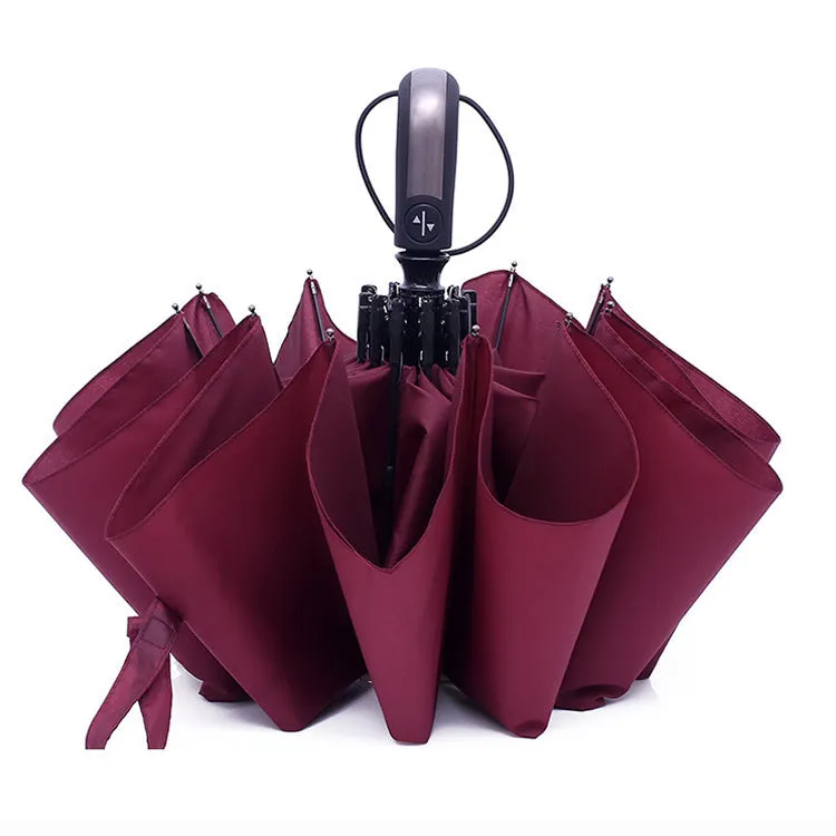Large black automatic triple-fold umbrella with palace style canopy and rubber handle.