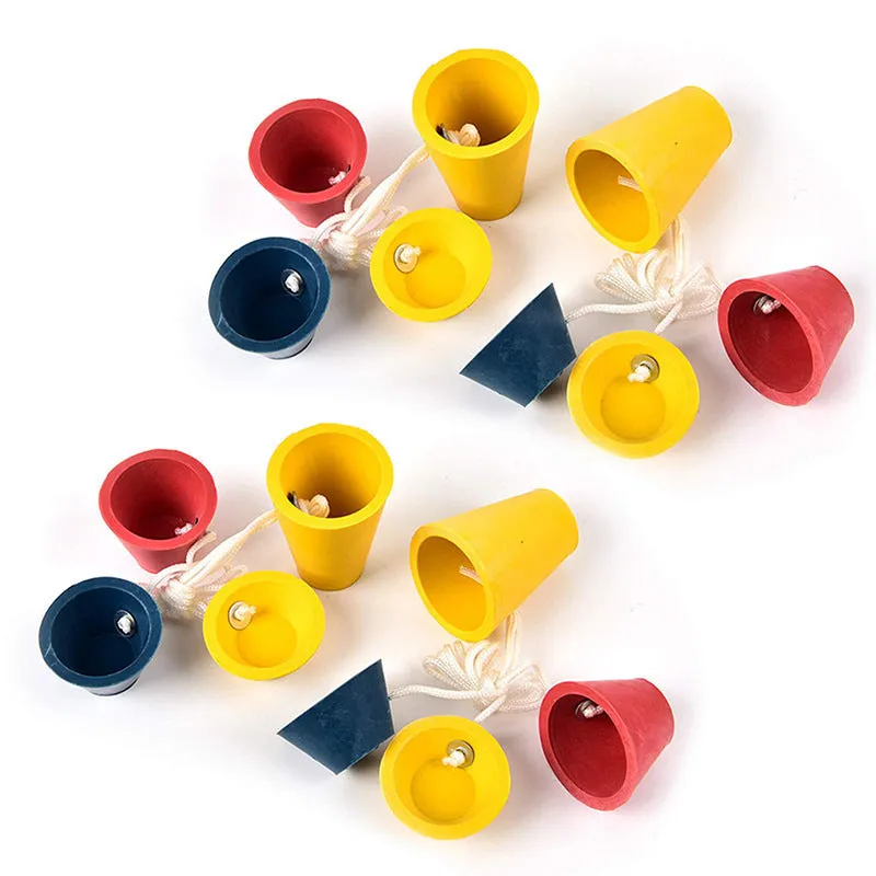 Set of four rubber golf tee ball holders in blue, yellow, and red with four feet each, 2cm height