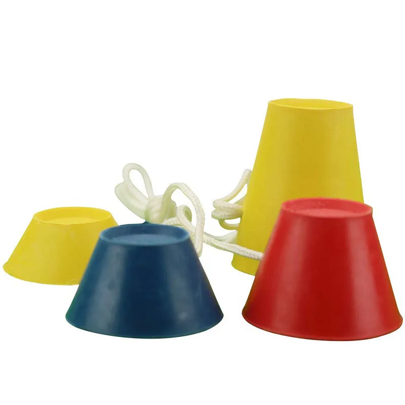 Set of four rubber golf tee ball holders in blue, yellow, and red with four feet each, 2cm height