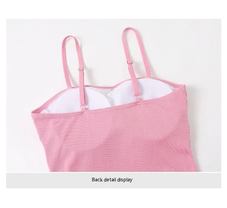 Women's long sleeve one-piece swimsuit in black or pink, made from polyester fabric.