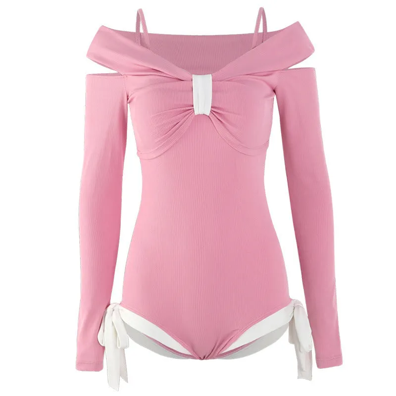 Women's long sleeve one-piece swimsuit in black or pink, made from polyester fabric.