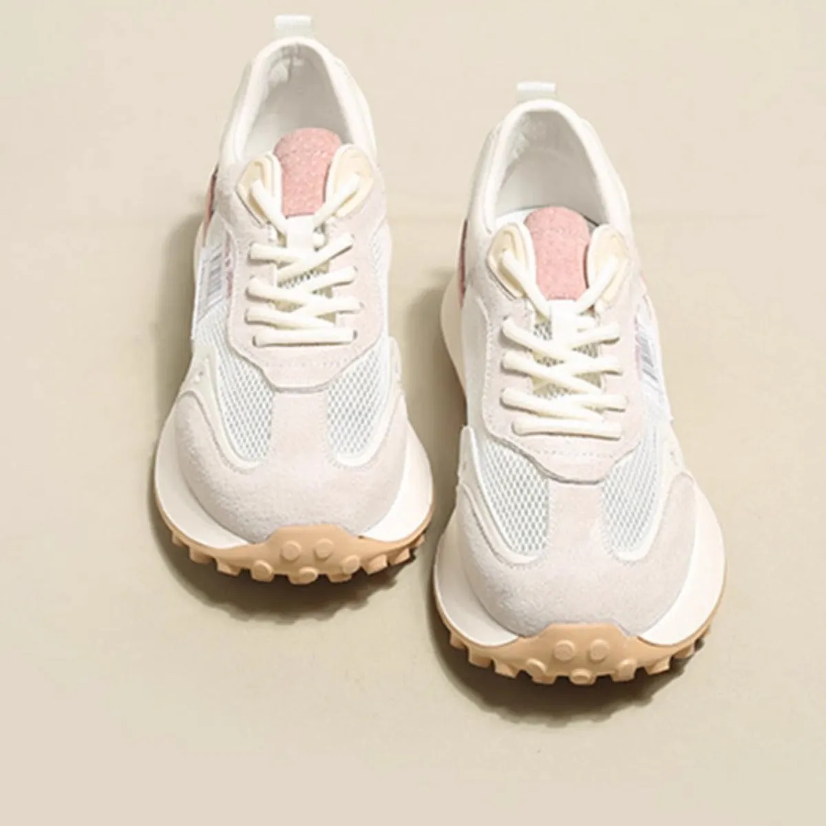 Women's grey and pink retro sneaker with low top design and round toe