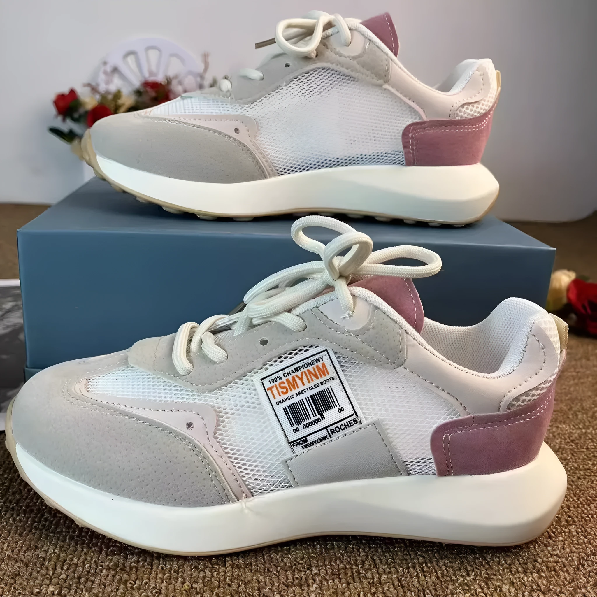 Women's grey and pink retro sneaker with low top design and round toe