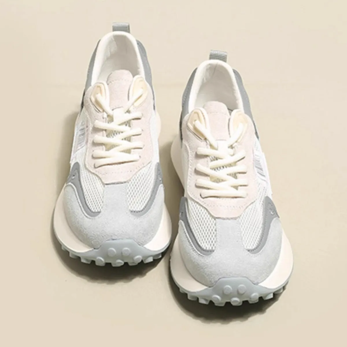 Women's grey and pink retro sneaker with low top design and round toe