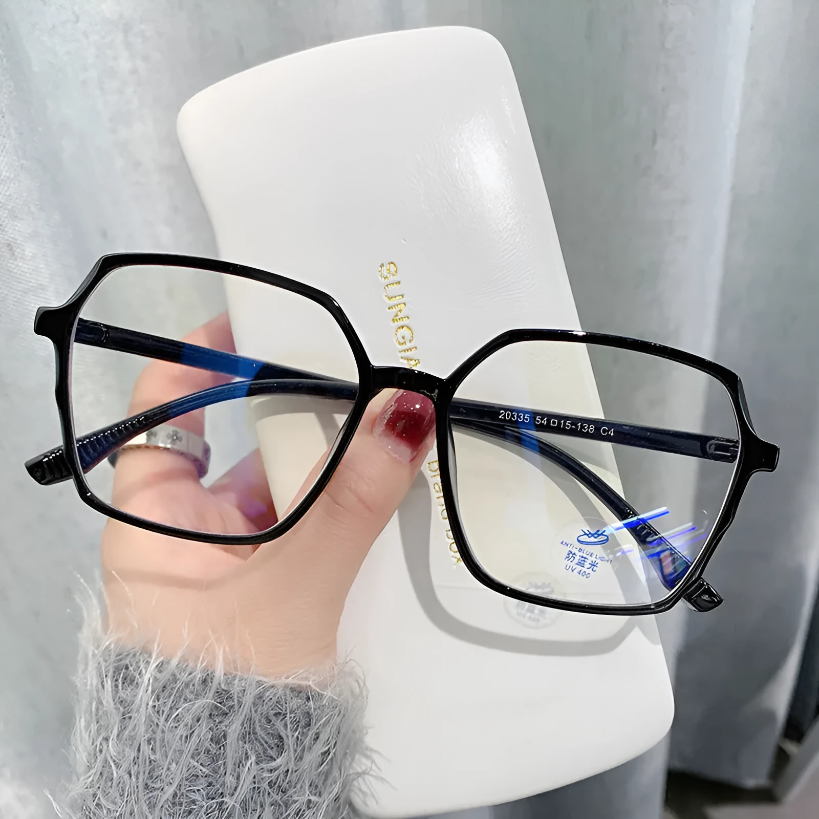 Women's fashion flat glasses with transparent plate frame and AC lenses on a white background