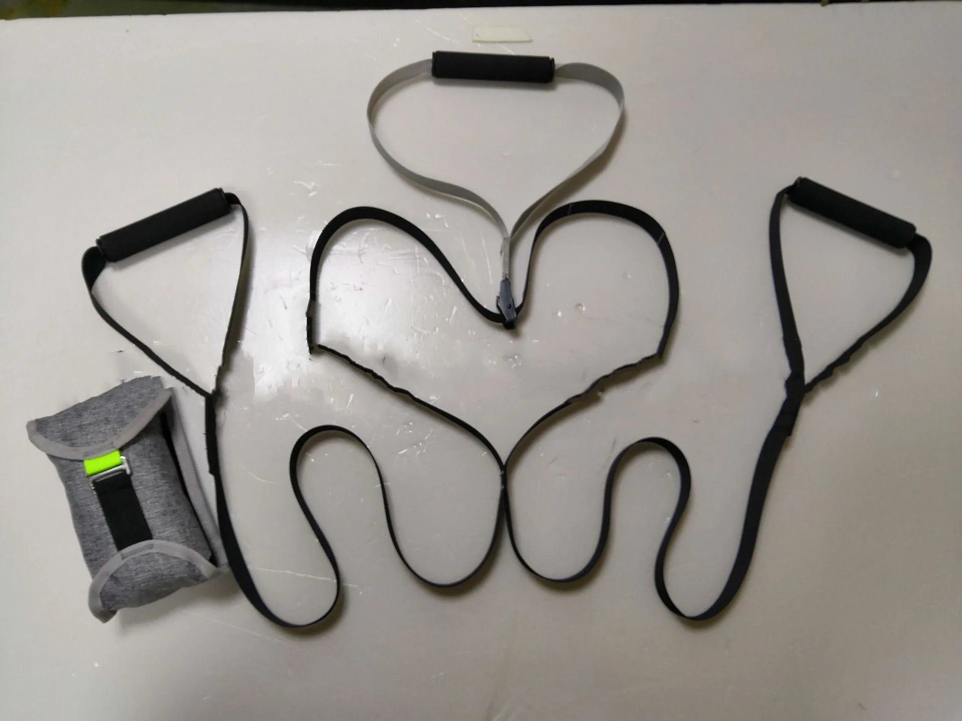 Black suspension training belt resistance band with nylon webbing strap and metal climbing hook