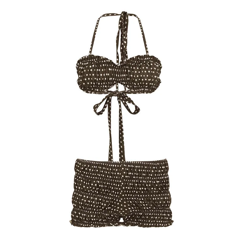 Brown polka dot women's shorts suit with sleeveless strap top and matching shorts on a summer seaside backdrop