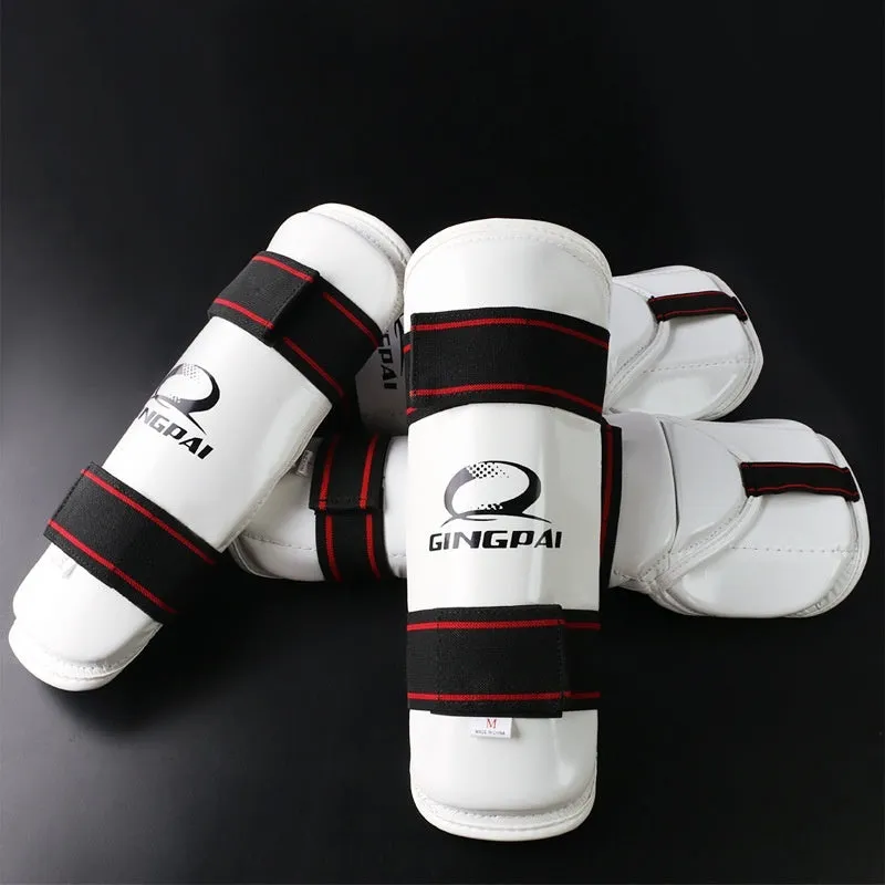 Taekwondo arm guards and leg protectors set in black PU EVA foam on a white background.