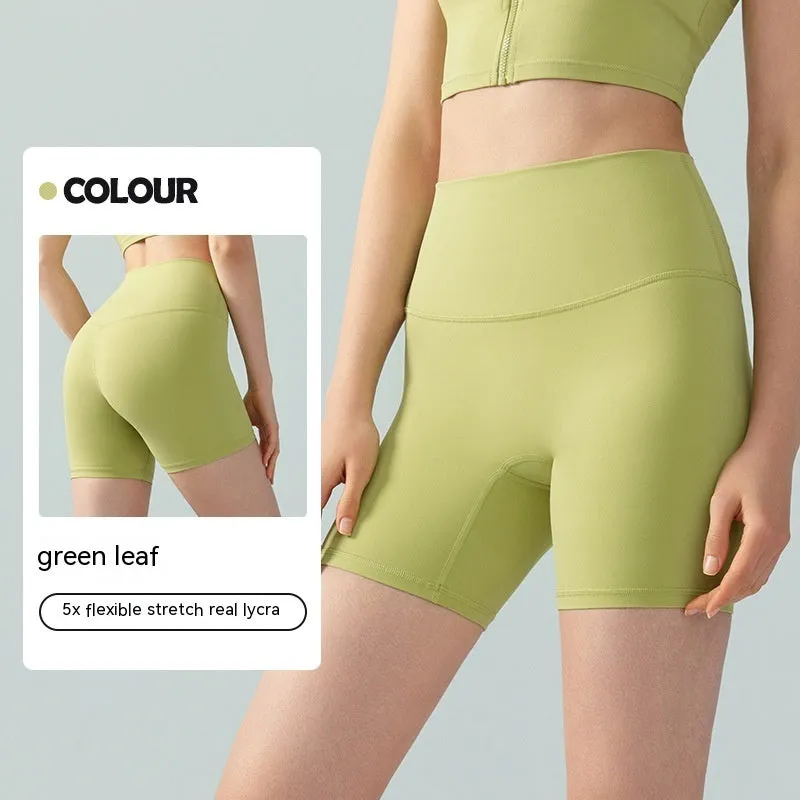 Woman wearing leaf green high waist Lycra yoga shorts for fitness exercise.
