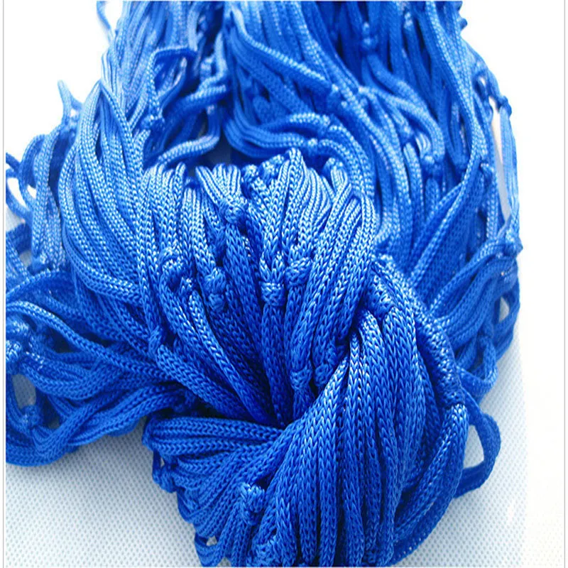 Nylon rope mesh hammock in bold blue on a green background with tie rope and cloth bag
