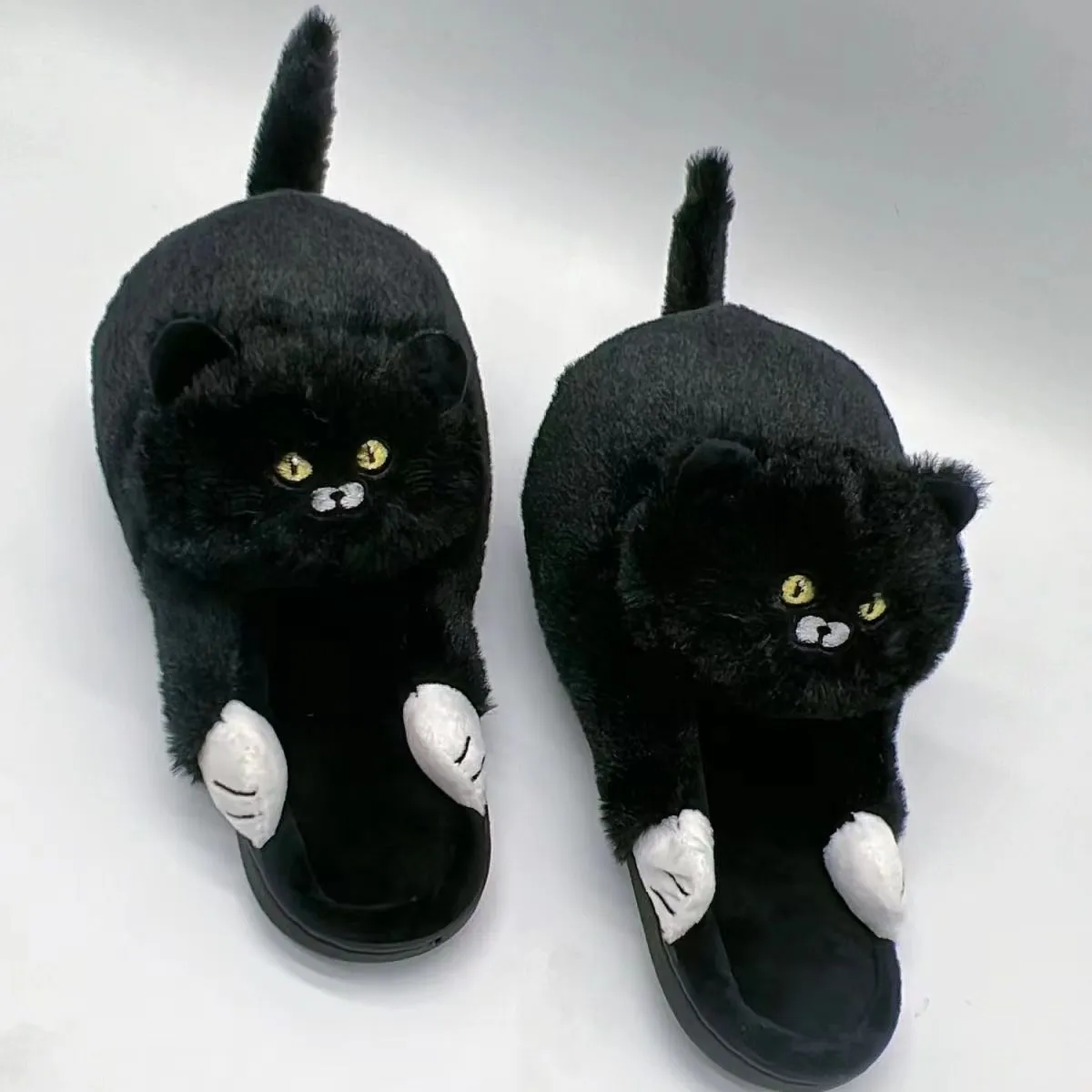 Pair of beige cat hug plush cotton slippers with non-slip sole on a soft floor