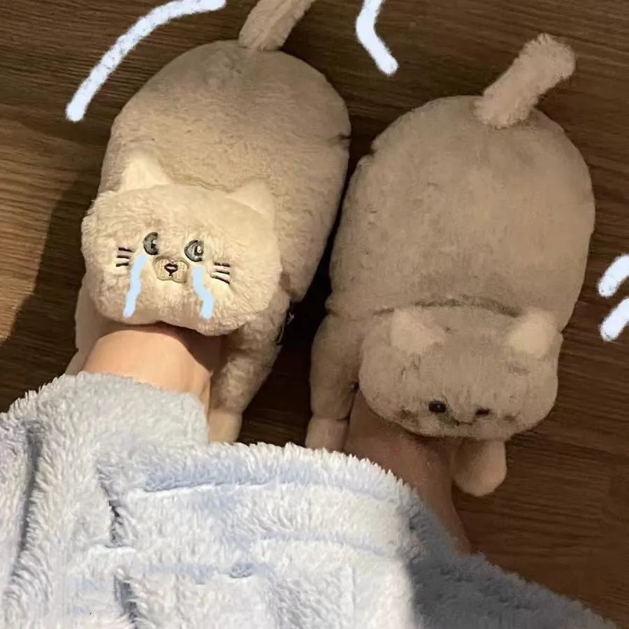 Pair of beige cat hug plush cotton slippers with non-slip sole on a soft floor