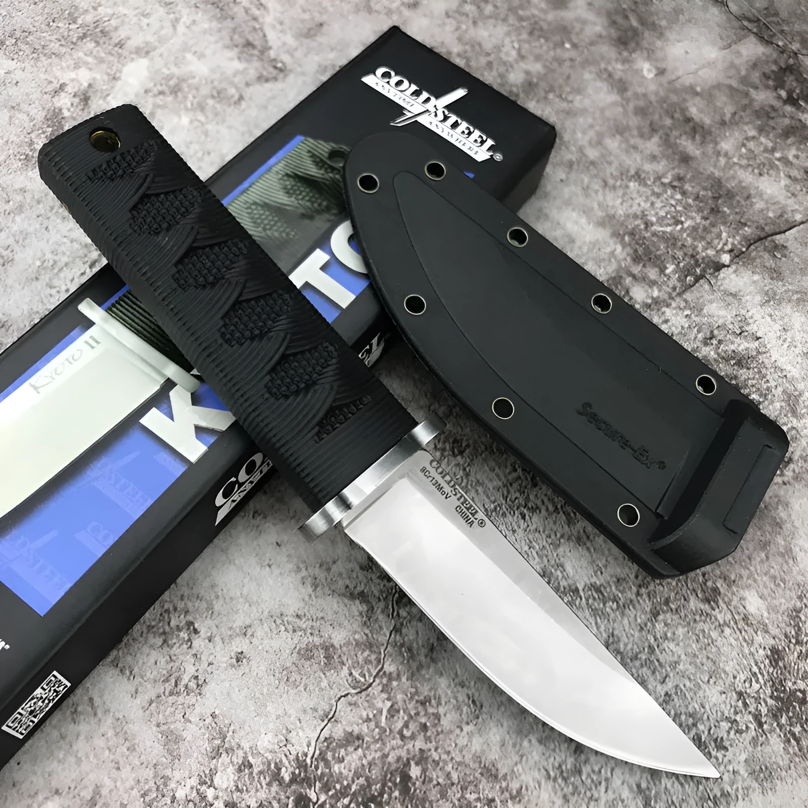 Mini fixed blade knife with 440C steel blade and ABS handle on a wooden surface