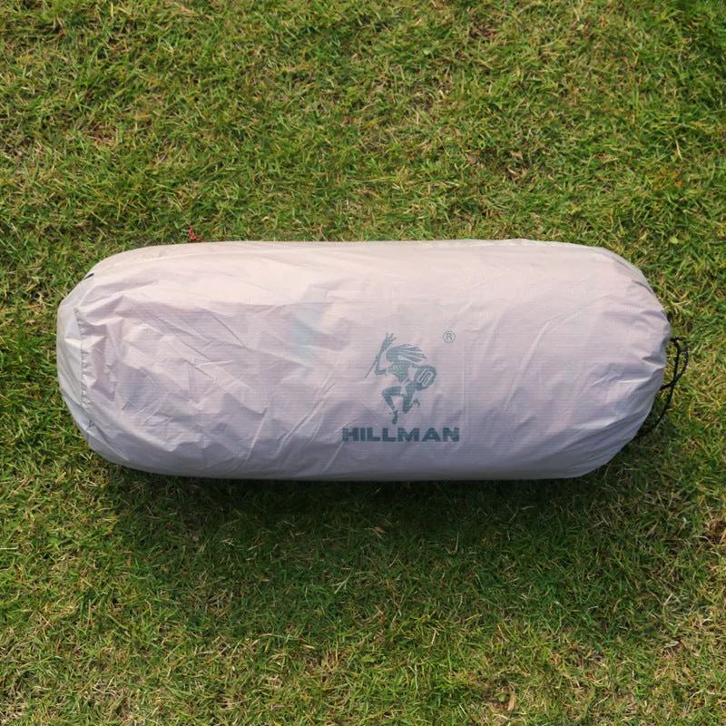 Grey outdoor multi-person tent with aluminium pole and 12 ground ropes set up on grass