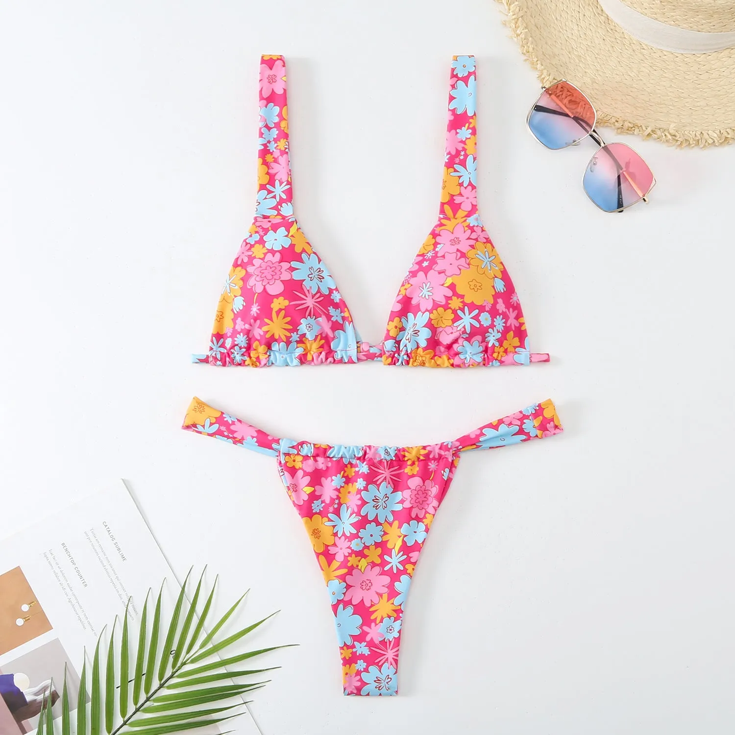 Women's floral print bikini swimsuit set in blue, with bra top and briefs.