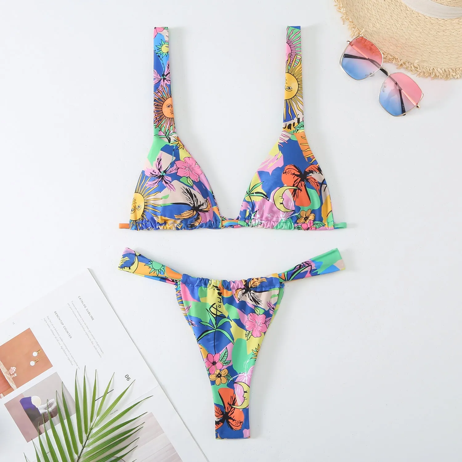 Women's floral print bikini swimsuit set in blue, with bra top and briefs.