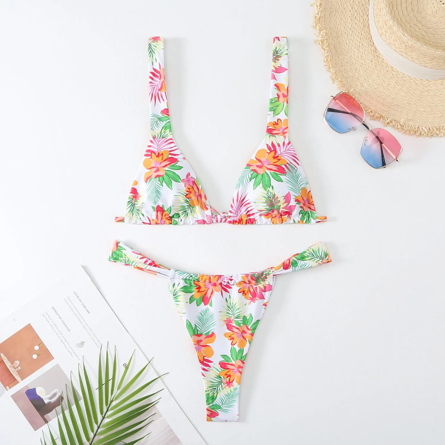 Women's floral print bikini swimsuit set in blue, with bra top and briefs.