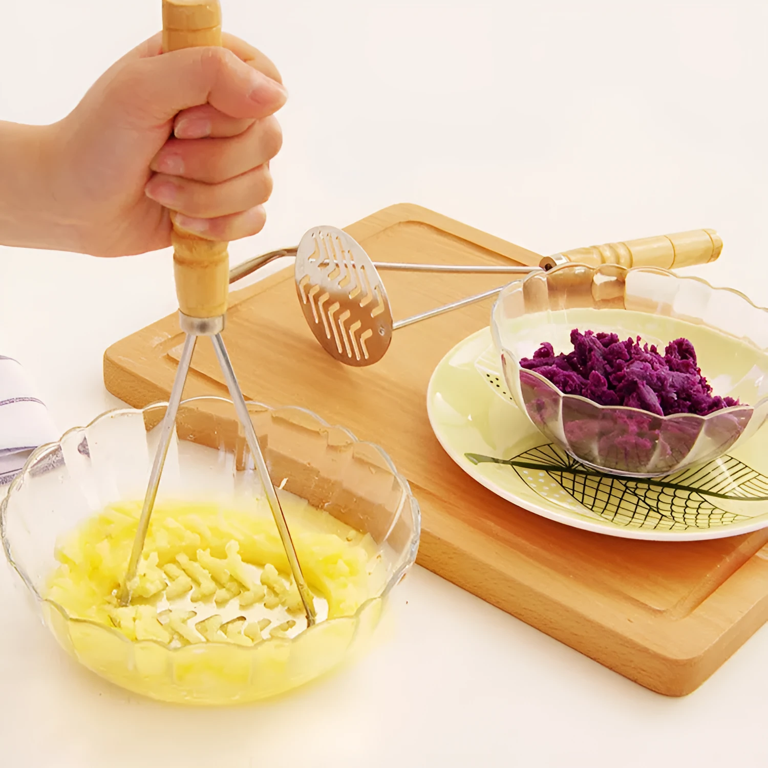 Manual potato masher with iron plated flower-shaped head and natural wooden handle