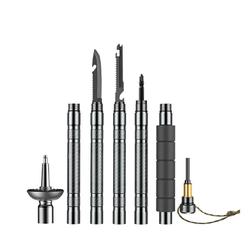 Dark grey aluminium trekking pole with tactical knife and screwdriver accessories on a hiking trail