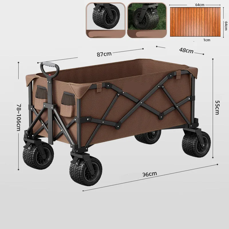 Foldable camping cart in black with 600kg capacity and push-pull handle on grass