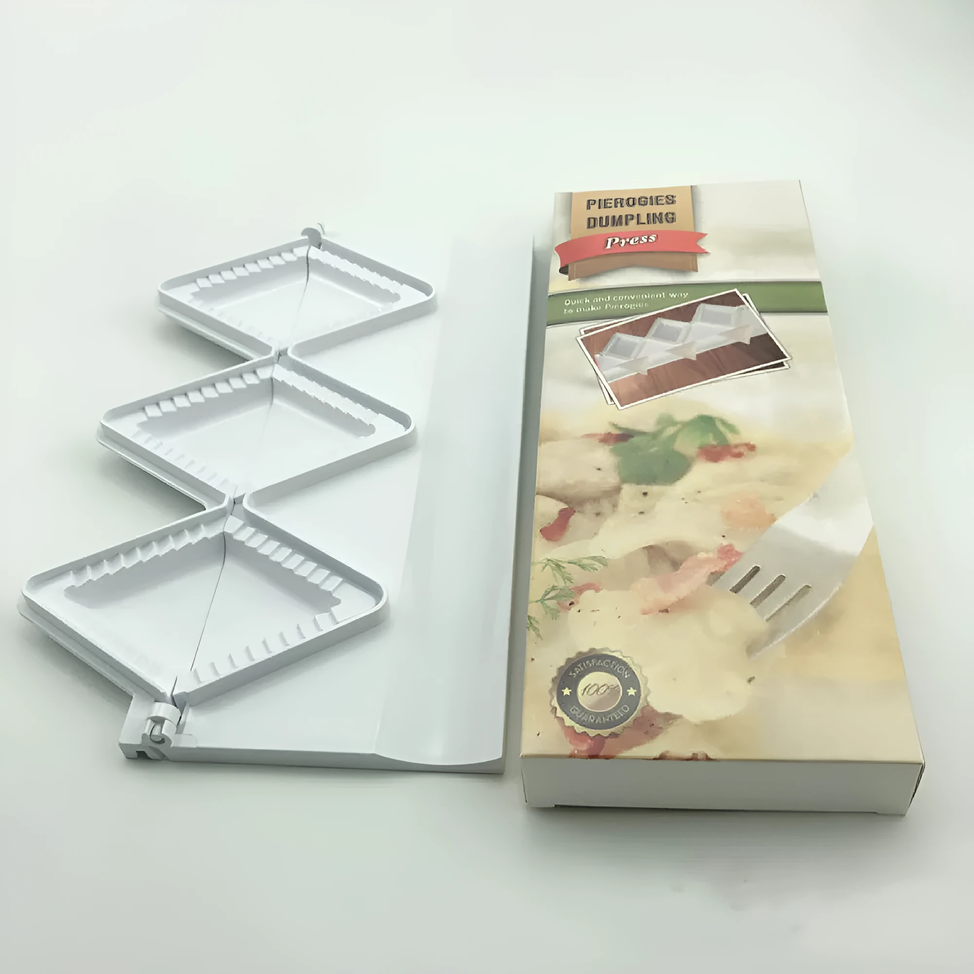 Pure white plastic dumpling maker 28.5cm length on a kitchen counter