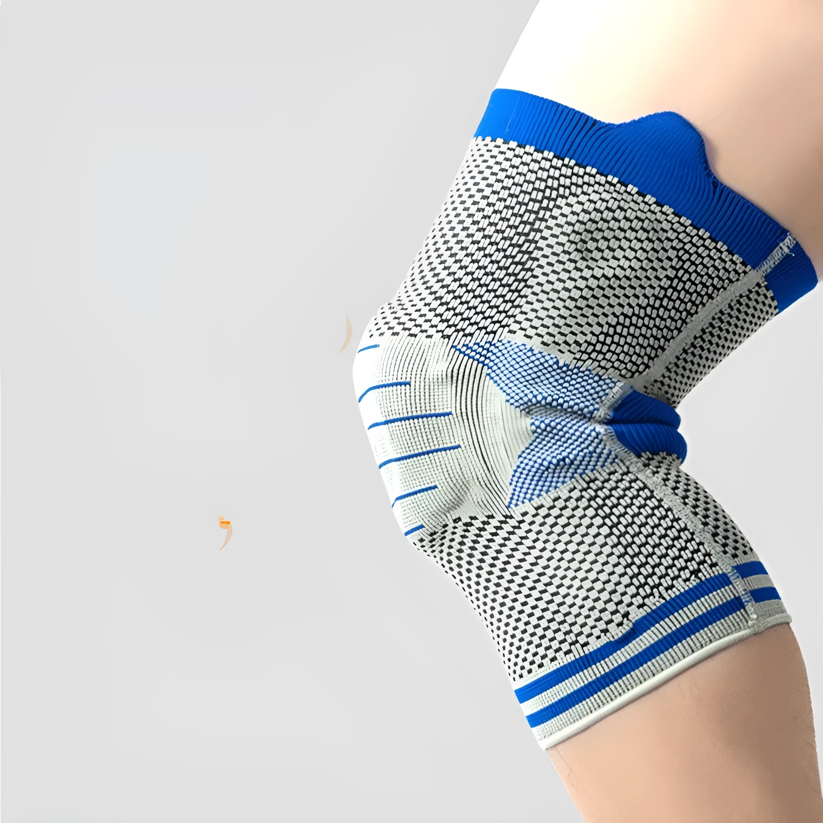 Silicone massage spring bar shock absorber knee protector in black and blue colour on leg.