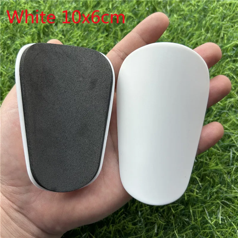 Pair of small black plastic football shin guards for junior players