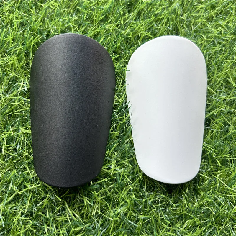 Pair of small black plastic football shin guards for junior players