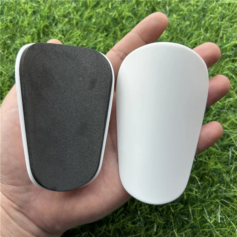 Pair of small black plastic football shin guards for junior players