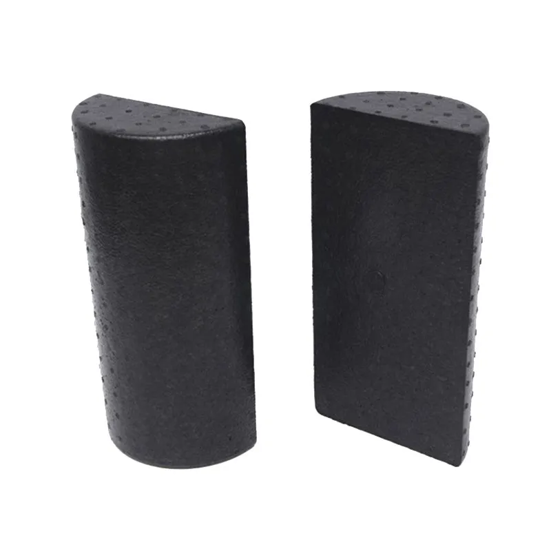 Black semi-circular EPP foam yoga roller 30cm on floor for muscle massage and stretching