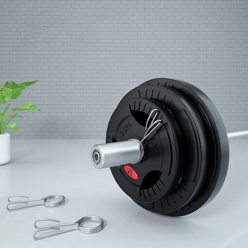 Black rubber covered cast iron barbell weight plates on gym floor