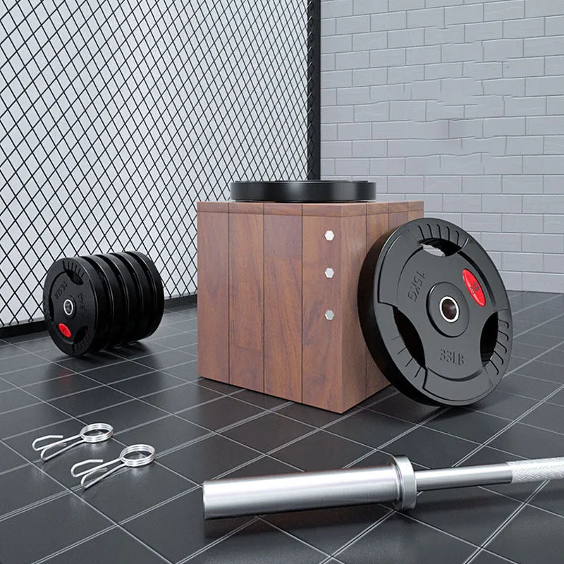 Black rubber covered cast iron barbell weight plates on gym floor