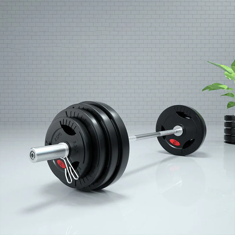 Black rubber covered cast iron barbell weight plates on gym floor