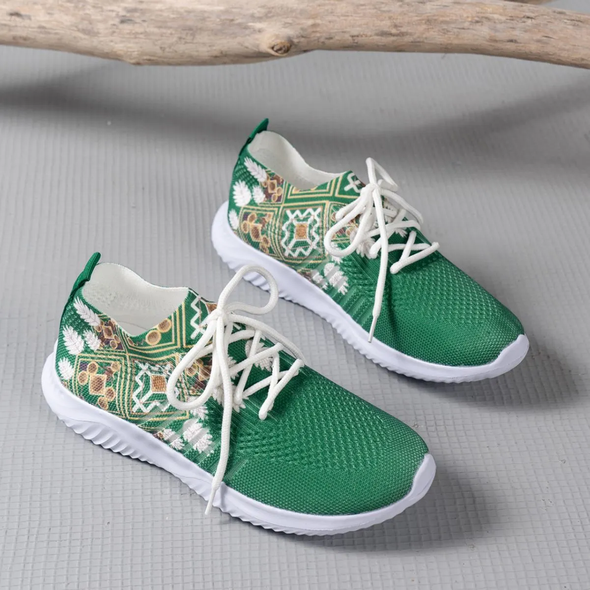 Women's woven flat shoes in green with printed totem detail, mesh upper, rubber sole, and front lace-up closure