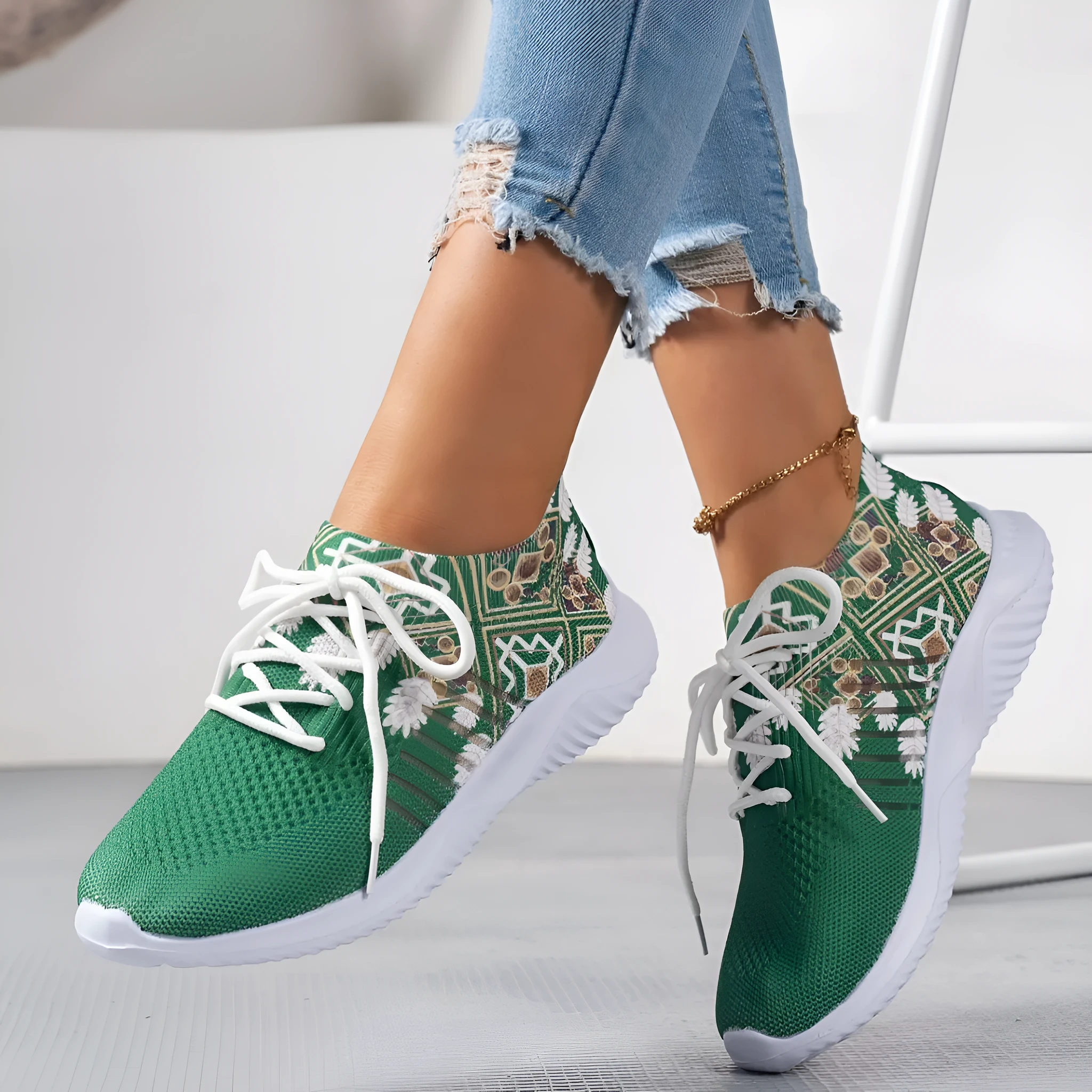 Women's woven flat shoes in green with printed totem detail, mesh upper, rubber sole, and front lace-up closure