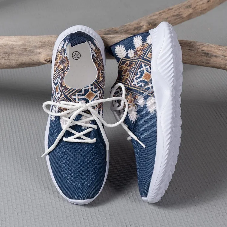 Women's woven flat shoes in green with printed totem detail, mesh upper, rubber sole, and front lace-up closure