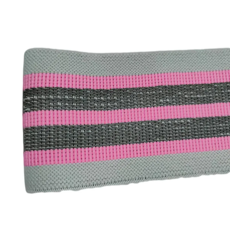 Fabric resistance band on a blue background showing two different colours for glute and yoga training