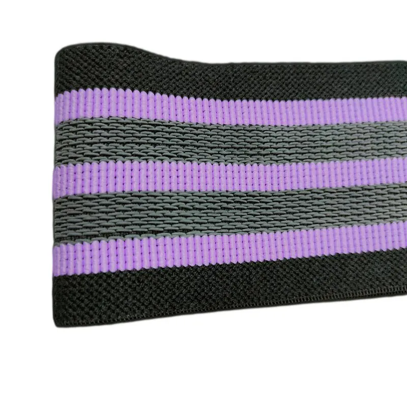 Fabric resistance band on a blue background showing two different colours for glute and yoga training