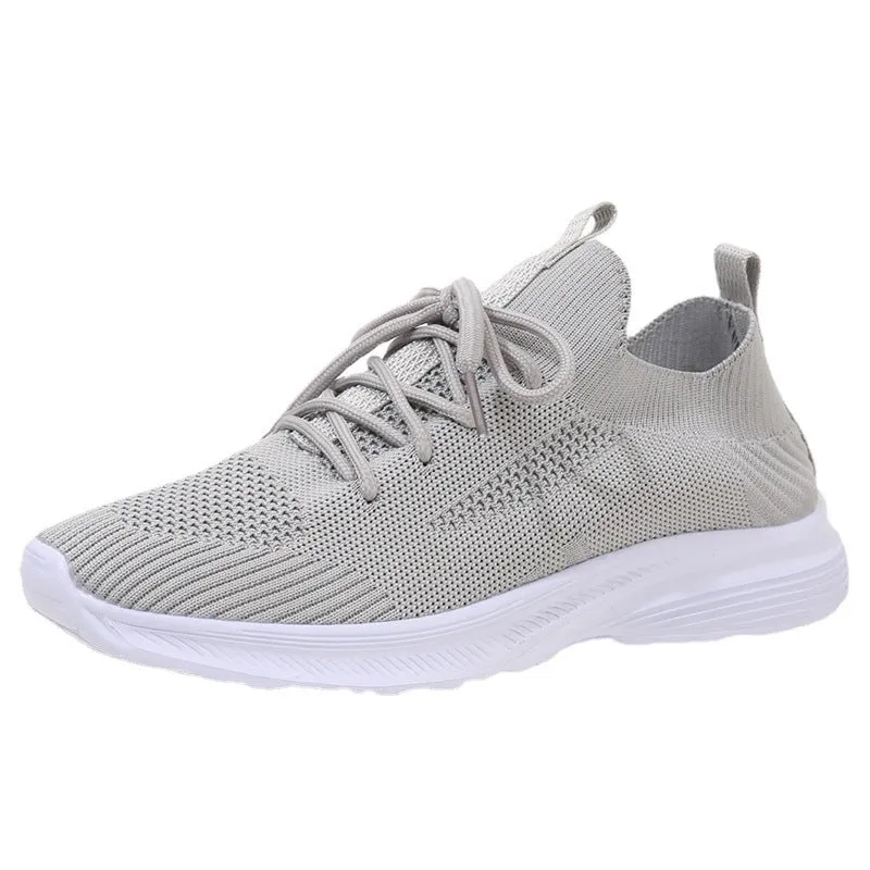 Women's low-top mesh running shoes in creamy white with a Flyknit upper and flat rubber sole.