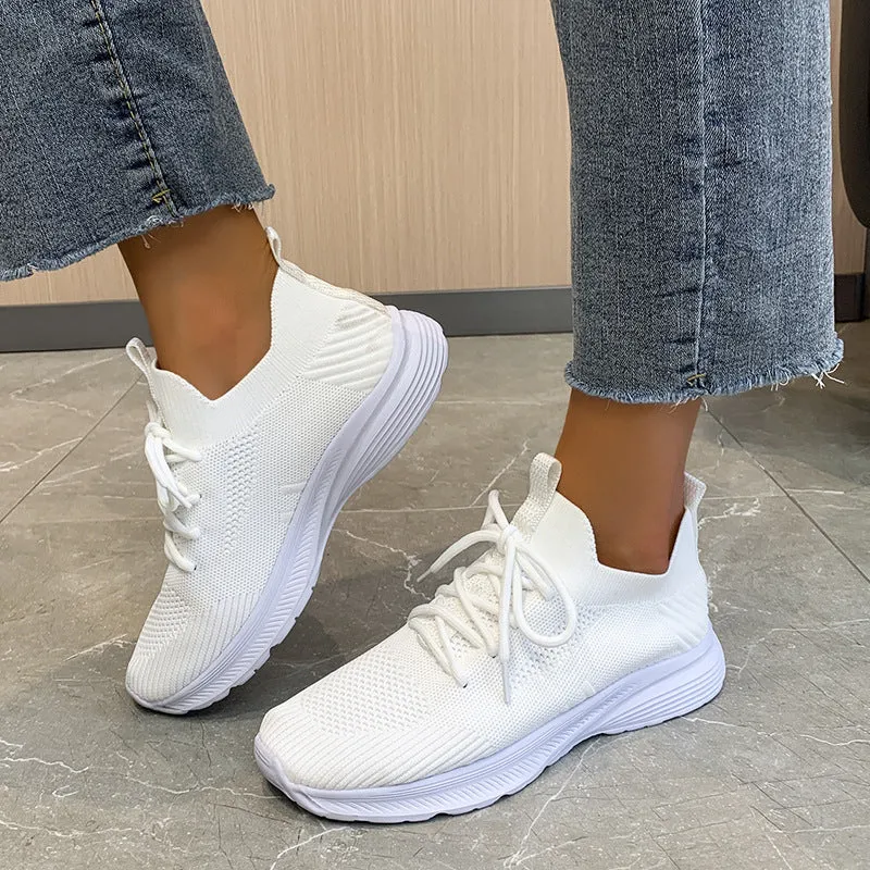 Women's low-top mesh running shoes in creamy white with a Flyknit upper and flat rubber sole.