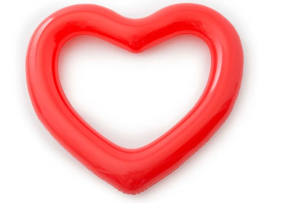 Oversized 120cm heart shaped swim ring in pink floating on water, adult outdoor pool toy