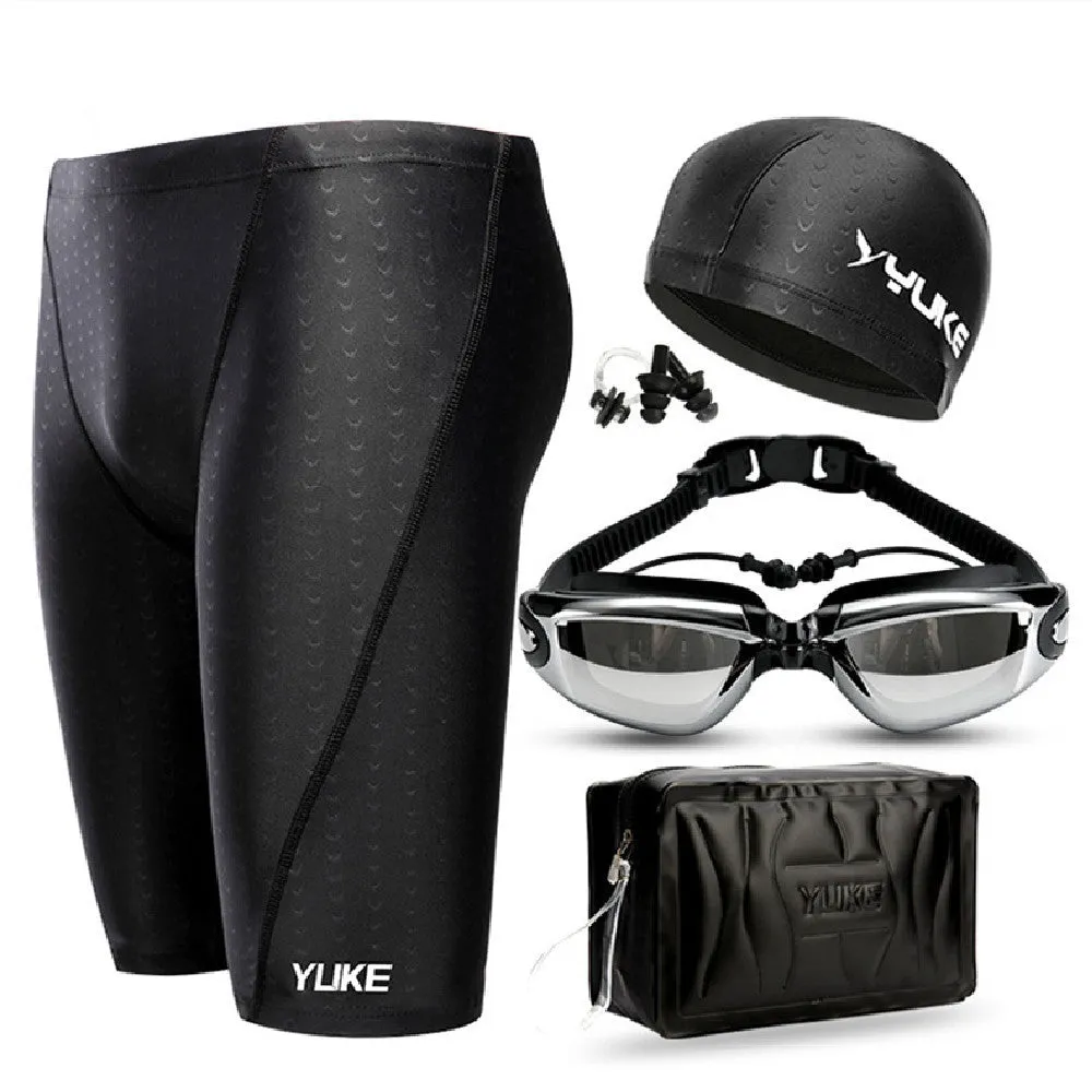 Men's black swimming set with briefs, goggles, cap, ear plugs, nose clip, and a carry bag laid out.